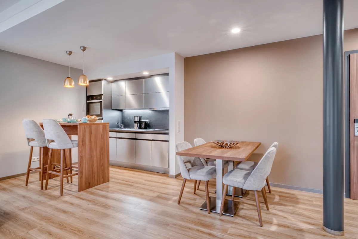 Apartment mit Küchenzeile, Tresen mit Barhockern und separatem Essplatz