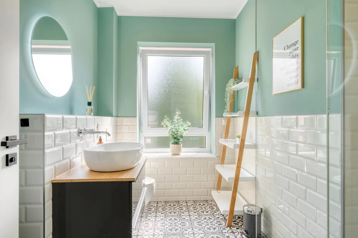Badezimmer in Mintgrün mit weißen Metrofliesen, Aufsatzwaschbecken und gemusterten Zementfliesen