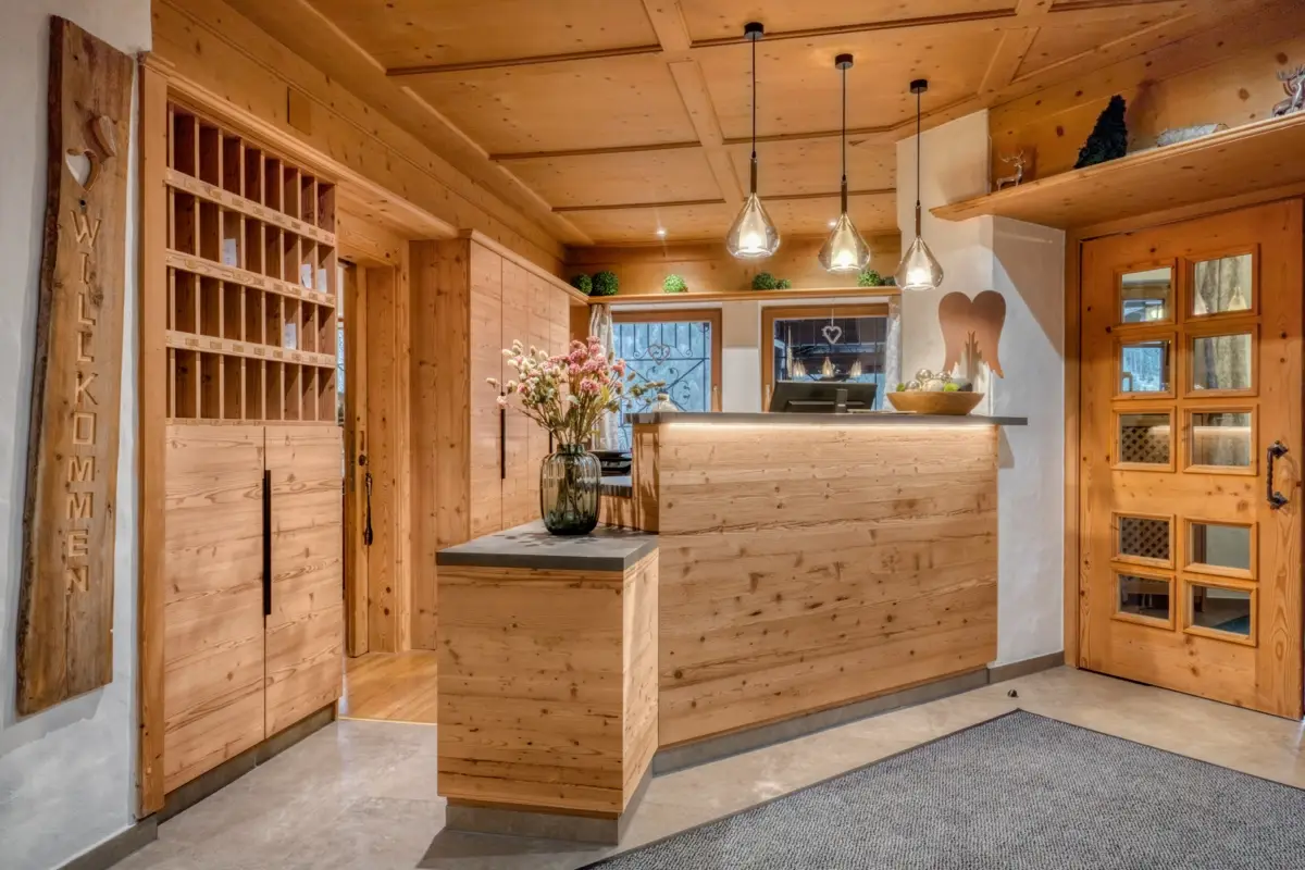 Reception with a timber counter and a carved welcome sign
