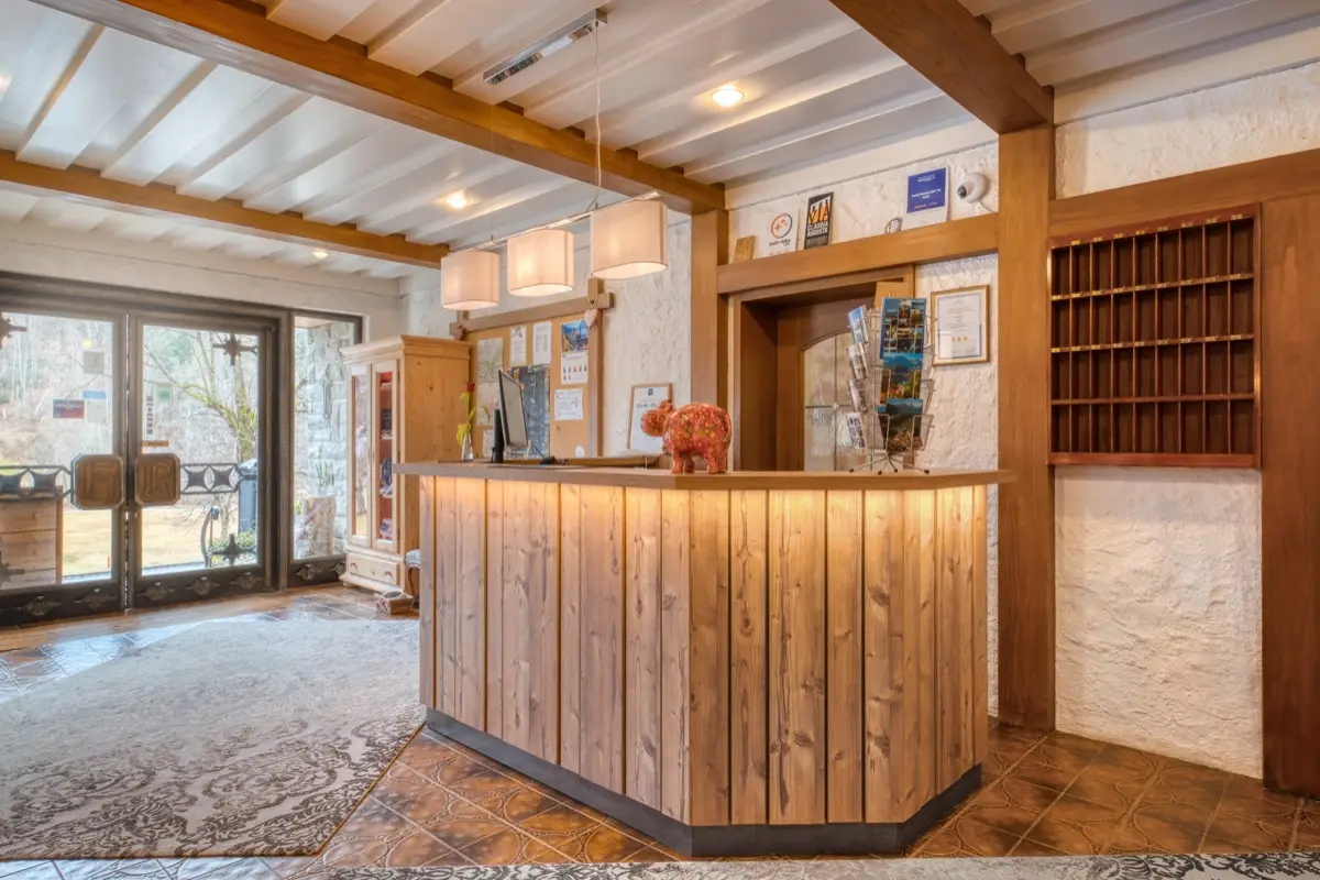 Timber reception counter with key pigeonholes behind it
