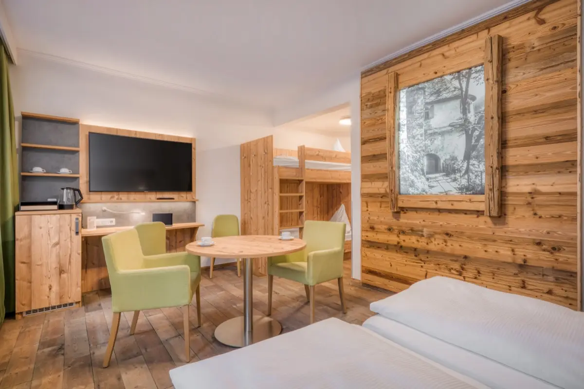 Family room with bunk beds, a dining corner and green chairs