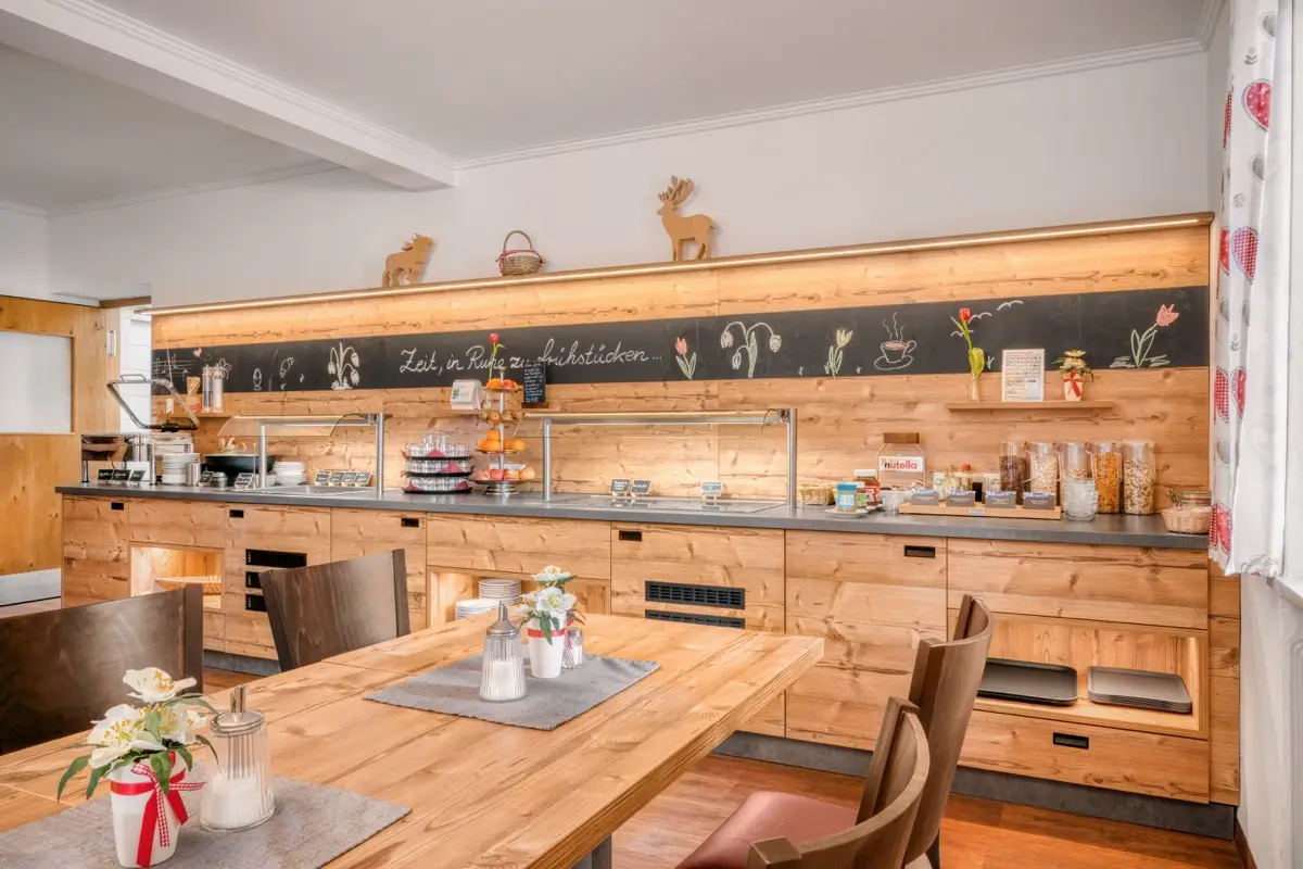 Breakfast buffet with a written slate board above it