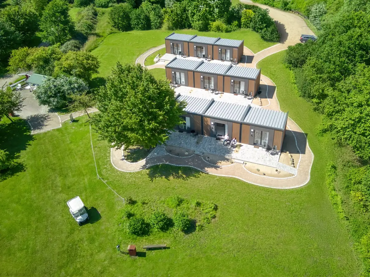 Aerial view of modern holiday lodges with terraces on a golf course