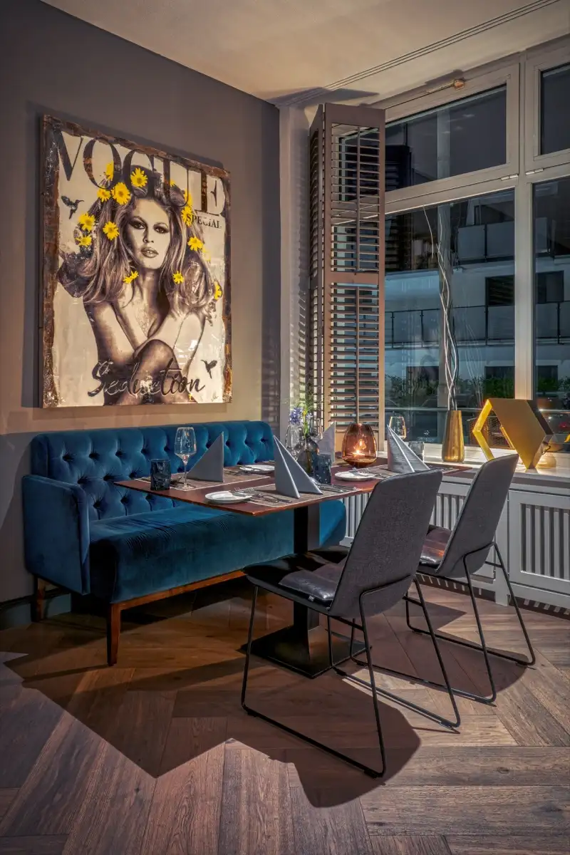 Blue velvet bench at a restaurant table, portrait format