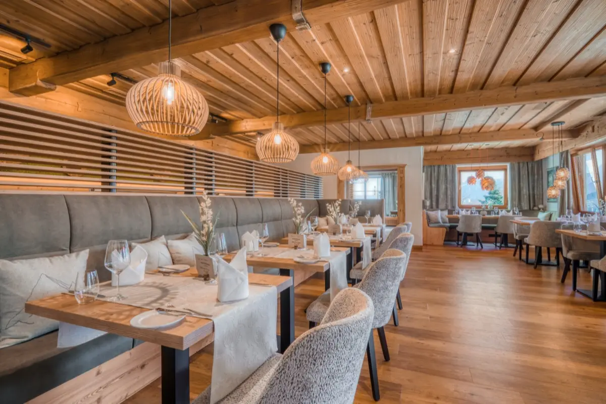 Restaurant parlour with a timber ceiling, wicker pendants and a long banquette